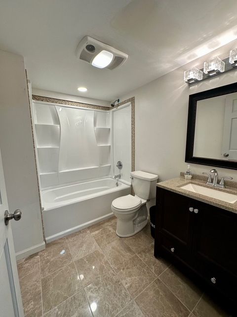 full bathroom featuring vanity, toilet, and bathing tub / shower combination