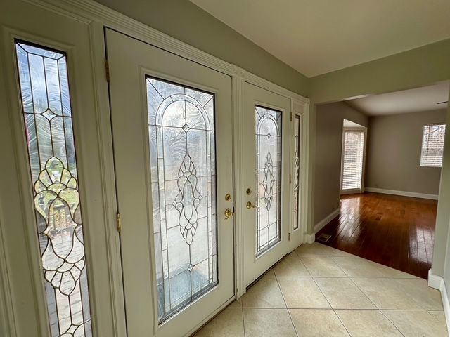 doorway with french doors and light wood-type flooring