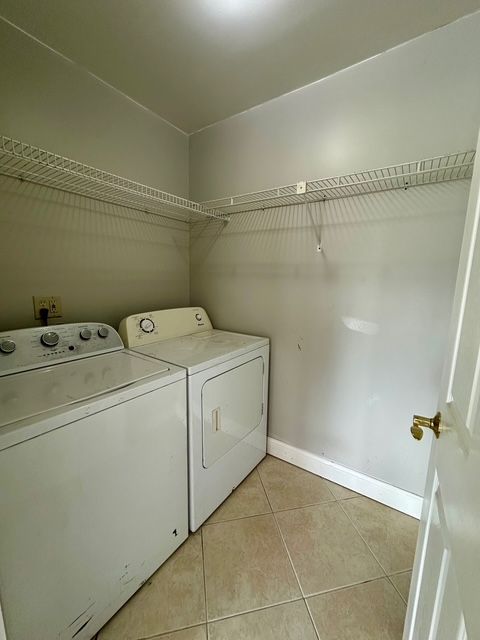 washroom featuring washer and dryer and light tile patterned floors