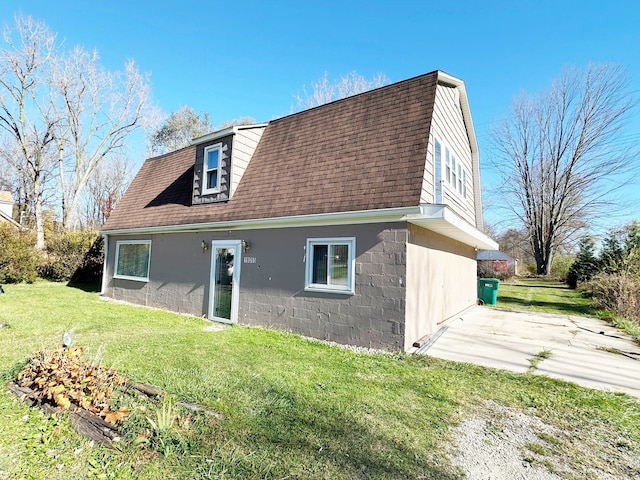 rear view of house with a patio area and a lawn