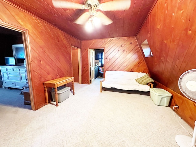 carpeted bedroom with lofted ceiling, ceiling fan, wooden ceiling, and wood walls