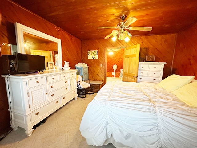 bedroom featuring wooden walls, ceiling fan, wooden ceiling, and light colored carpet