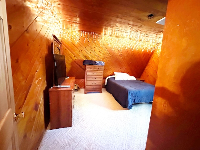 carpeted bedroom featuring wooden walls, wooden ceiling, and vaulted ceiling