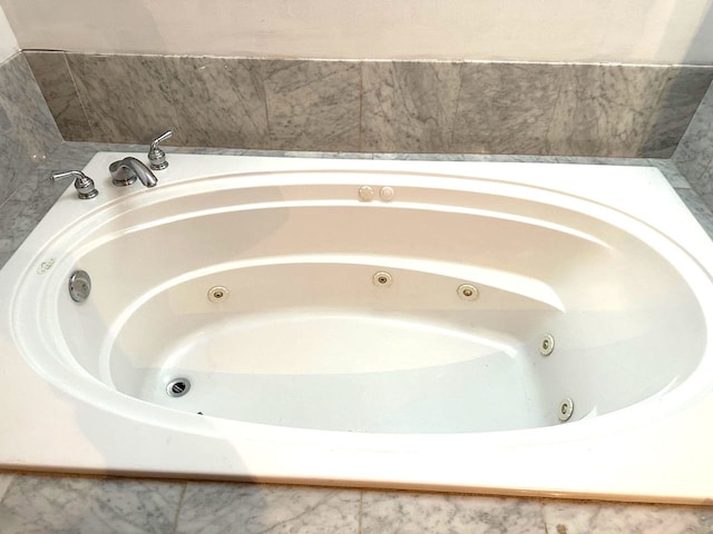 bathroom with a relaxing tiled tub