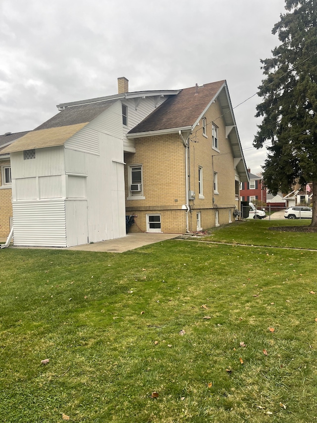 back of property with a patio area and a yard