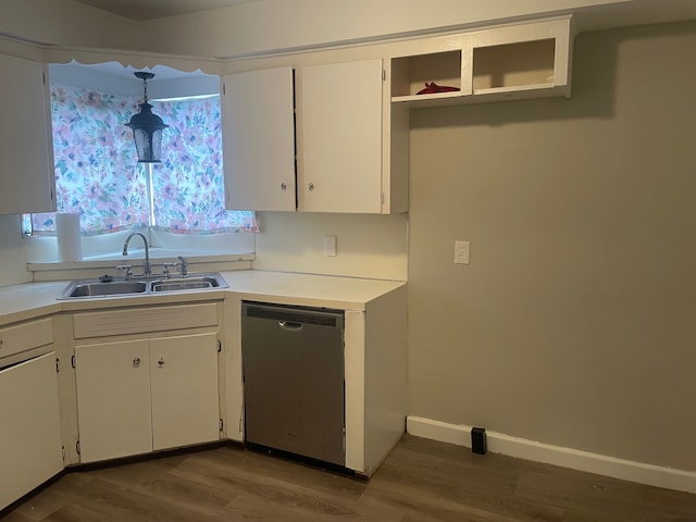 kitchen with sink, dark hardwood / wood-style flooring, stainless steel dishwasher, pendant lighting, and white cabinets