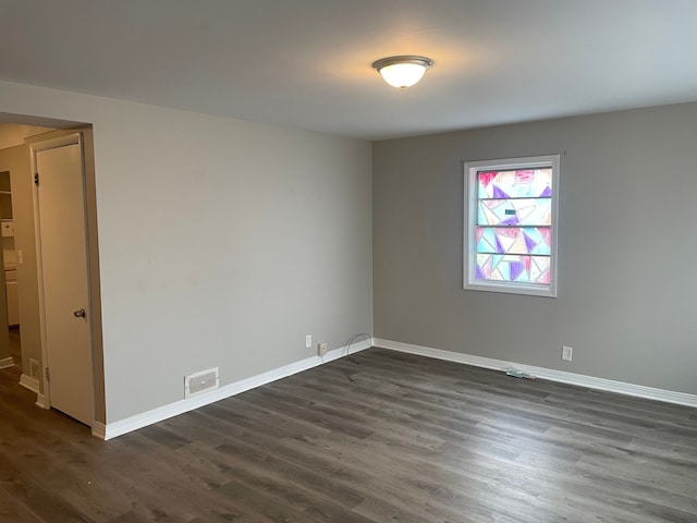 spare room with dark hardwood / wood-style floors