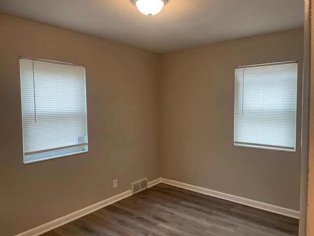 spare room featuring dark hardwood / wood-style floors