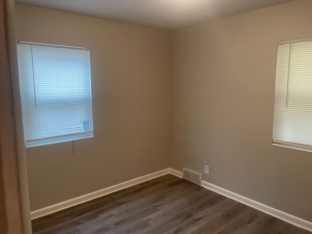 unfurnished room with dark hardwood / wood-style floors