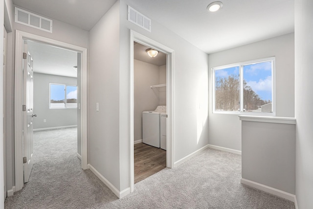 washroom with laundry area, carpet, visible vents, and separate washer and dryer