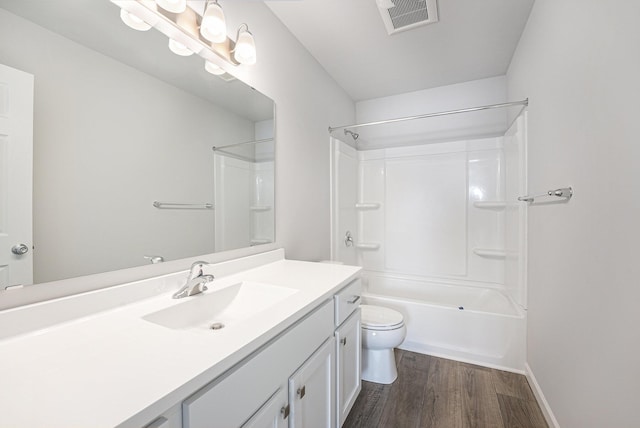 bathroom featuring toilet, wood finished floors, vanity, visible vents, and tub / shower combination