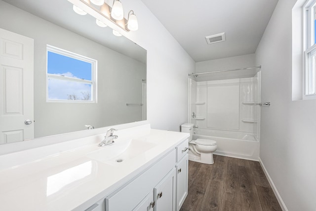 bathroom featuring baseboards, visible vents, toilet, wood finished floors, and vanity