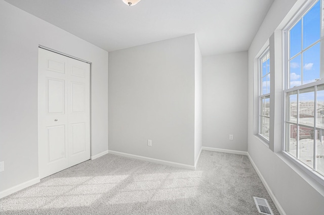 unfurnished bedroom with carpet and baseboards