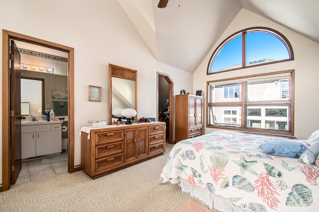 bedroom featuring ensuite bath, ceiling fan, sink, high vaulted ceiling, and light tile patterned floors