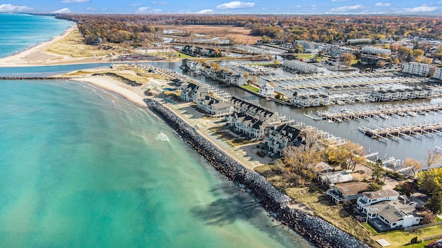 drone / aerial view featuring a water view and a beach view