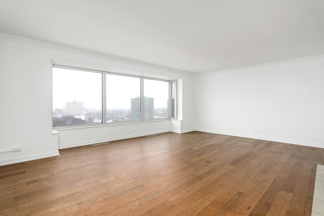 unfurnished room featuring crown molding and wood-type flooring