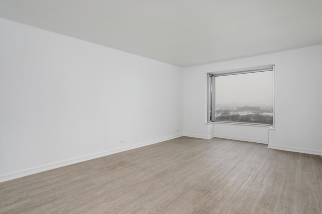 empty room with light hardwood / wood-style flooring