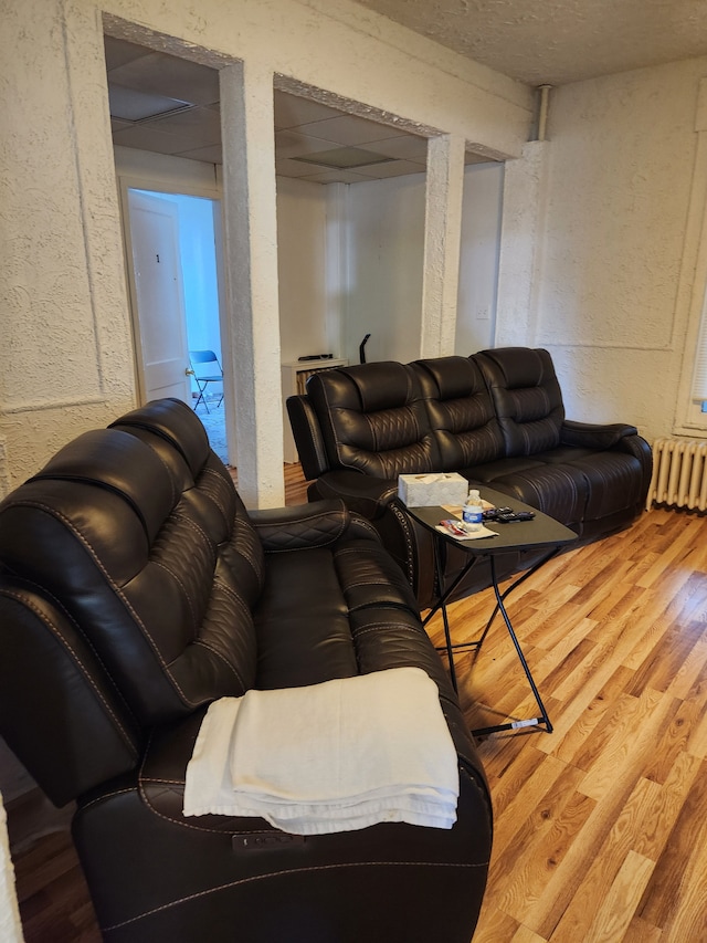 living room featuring hardwood / wood-style floors and radiator heating unit