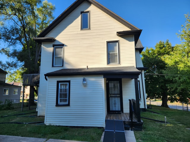 back of property featuring a lawn