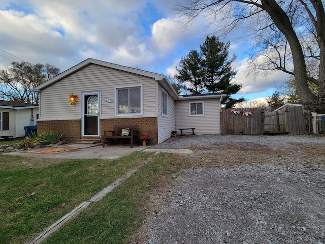 back of house featuring a lawn