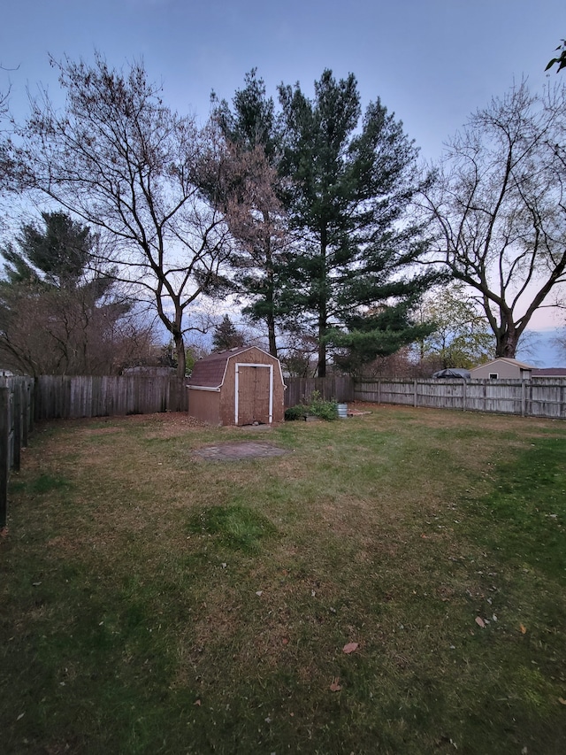 yard at dusk with a storage unit