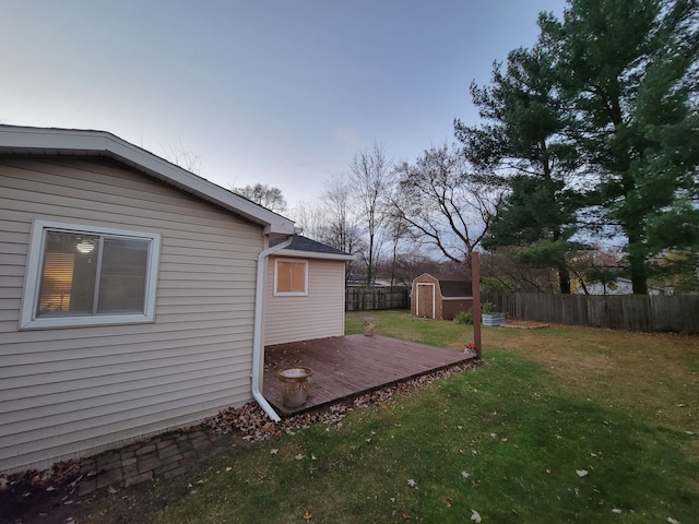 view of yard with a deck and a shed