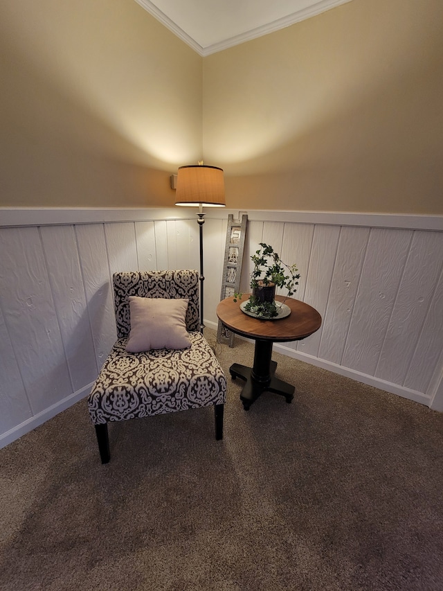 sitting room featuring carpet flooring and ornamental molding