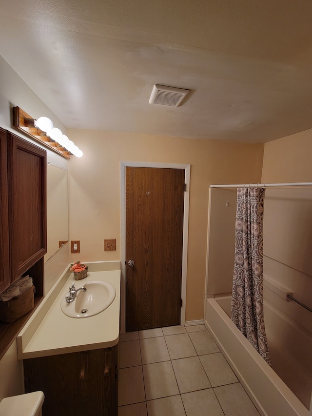 bathroom with vanity, tile patterned flooring, and shower / bath combo with shower curtain