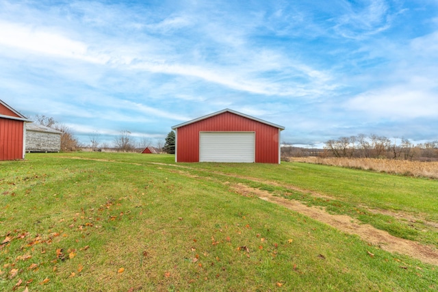 view of yard with a garage and an outdoor structure