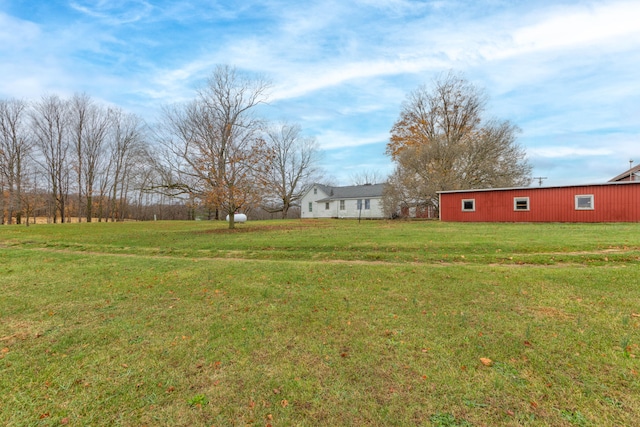 view of yard with a rural view and an outdoor structure