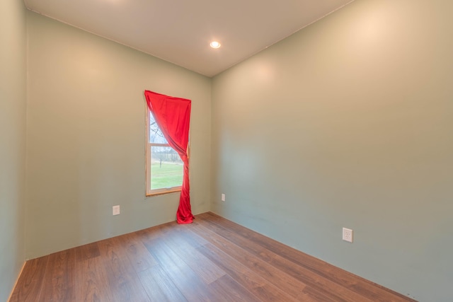 unfurnished room featuring hardwood / wood-style flooring