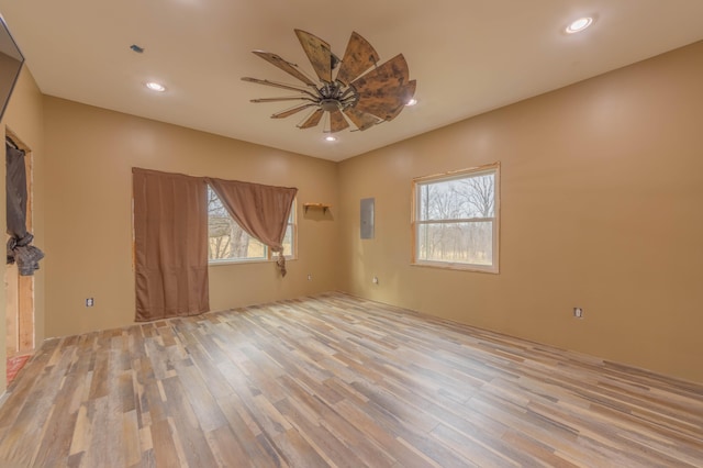 spare room with ceiling fan and light wood-type flooring