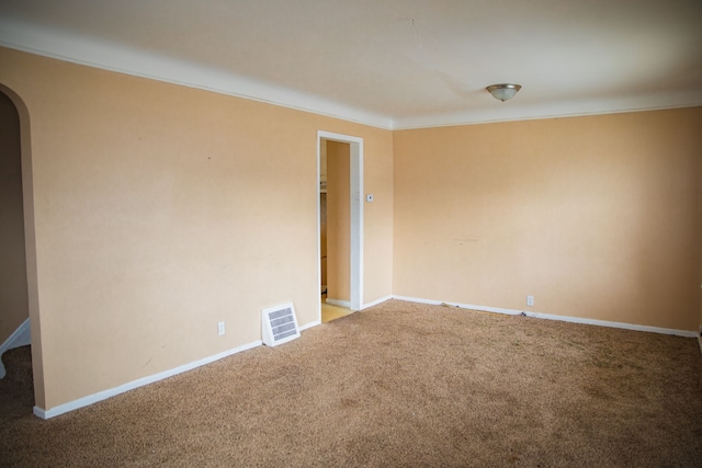 spare room with crown molding and carpet floors