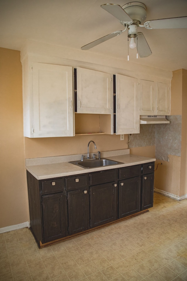 kitchen featuring sink, white cabinets, and ceiling fan