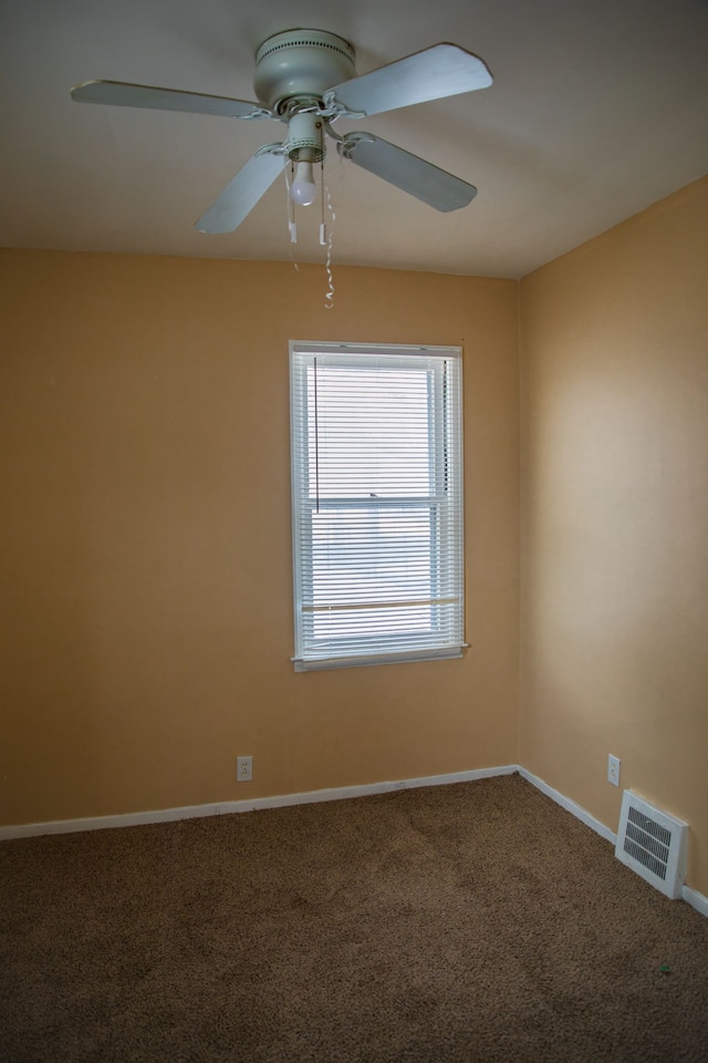 spare room featuring carpet floors and ceiling fan