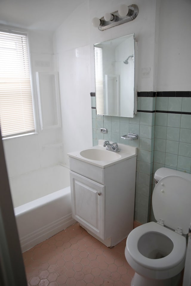 full bathroom with vanity, toilet, tile patterned flooring, and tile walls