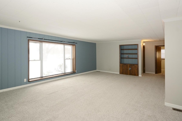 carpeted spare room with ornamental molding