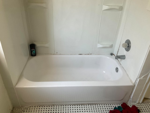 bathroom featuring tile patterned flooring and a bathtub