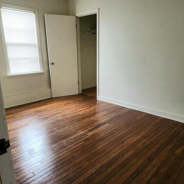 unfurnished room with hardwood / wood-style flooring