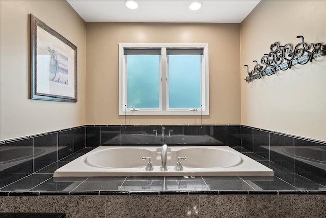 bathroom featuring tiled tub