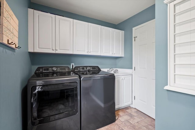 washroom featuring cabinets, independent washer and dryer, and sink