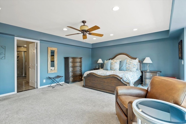 bedroom featuring light carpet, connected bathroom, and ceiling fan