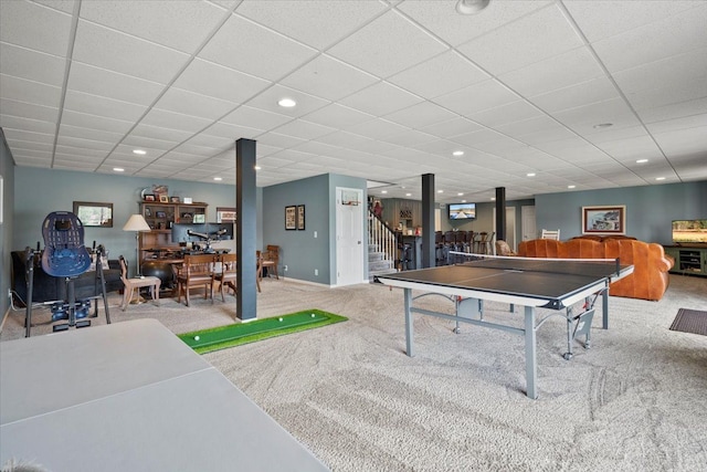 playroom with light carpet and a paneled ceiling