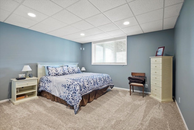 bedroom with carpet flooring and a drop ceiling