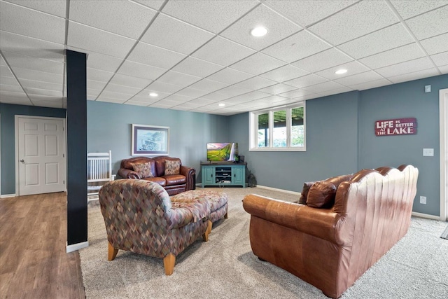 living room with hardwood / wood-style floors, a paneled ceiling, and a healthy amount of sunlight