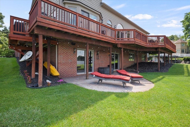 rear view of house with a lawn, a patio area, and a wooden deck