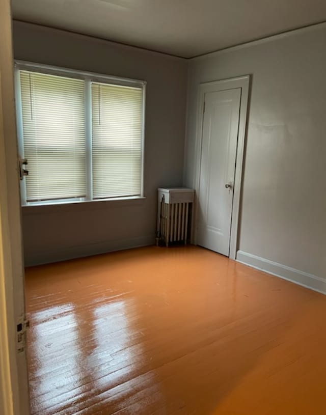 empty room with light hardwood / wood-style floors and a healthy amount of sunlight