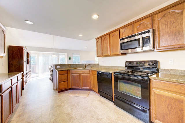 kitchen featuring sink, light hardwood / wood-style flooring, kitchen peninsula, decorative light fixtures, and black appliances