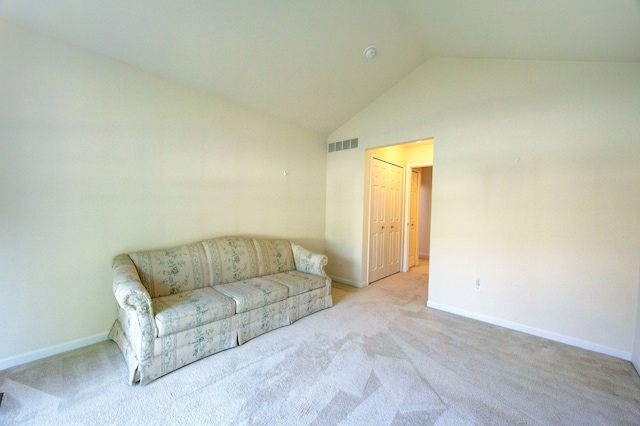 carpeted living room featuring lofted ceiling