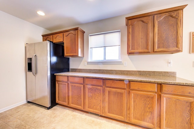 kitchen featuring stainless steel refrigerator with ice dispenser